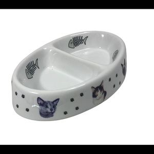 Divided cat dish with fish skeletons and paw prints